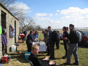 Walkers receiving sausages in bread roll and drinks at halfway on long route